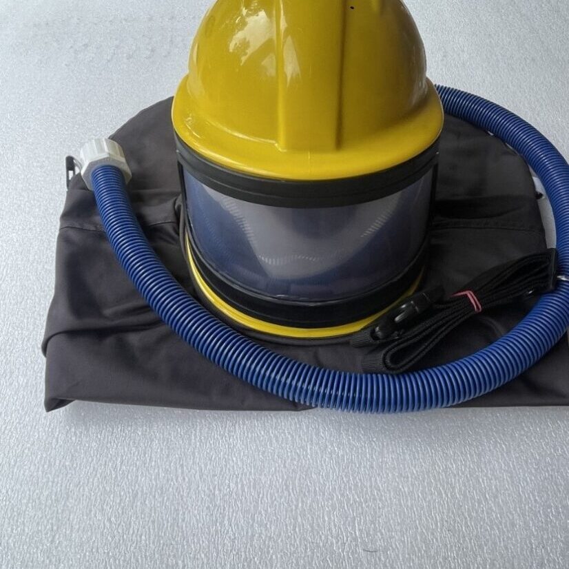 A yellow helmet and hose on top of the floor.